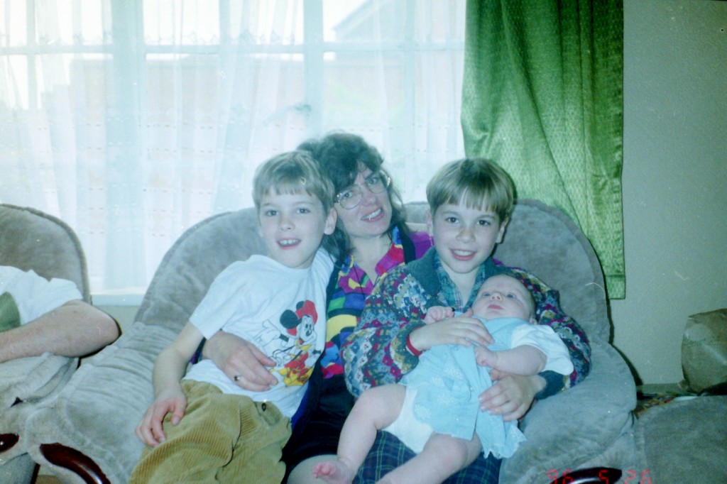 Left to right, Garreth, Mum, myself, and a baby B (cousin). Oh, and you can also see my Uncle C's arm on the left.